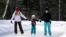 Monica Bourque, left, skates with daughter Katherine Rupay, 5, and sister Lisa Bourque at Patinage en Foret, or Skating Through the Forest, in Lac des Loups, Quebec, on Friday, Jan. 26, 2018. THE CANADIAN PRESS/Justin Tang