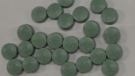 Police say two sets of counterfeit green pills were seized. (Courtesy Windsor police)
