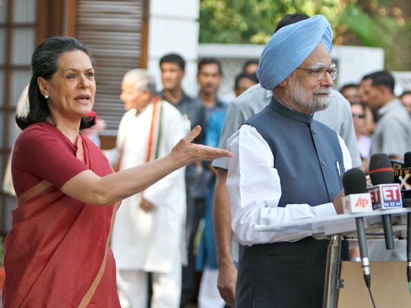 Congress Party President Sonia Gandhi, left, requests Indian Prime Minister Manmohan Singh address the media in New Delhi, India, on Saturday, May 16, 2009. (AP / Saurabh Das)