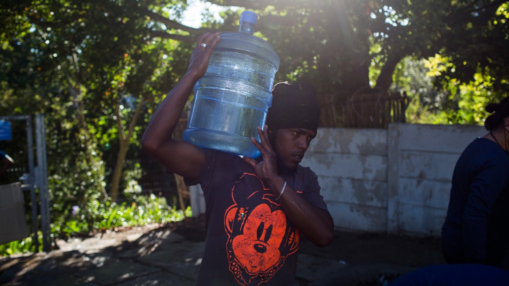 A man carries water in Cape Town
