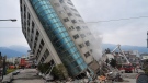 A residential building leans on a collapsed first floor following an earthquake, Wednesday, Feb. 7, 2018, in Hualien, southern Taiwan. (Central News Agency)