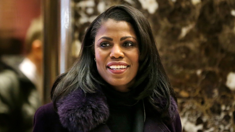 In this Dec. 13, 2016 file photo, Omarosa Manigault smiles at reporters as she walks through the lobby of Trump Tower in New York. Manigault Newman is a cast member on "Celebrity Big Brother," premiering Thursday on CBS. (AP Photo/Seth Wenig)