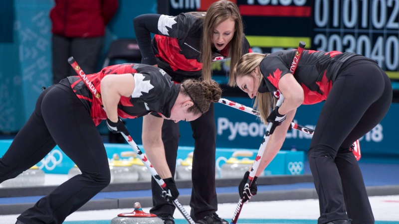 Canada's skip Rachel Homan directs Joanne Courtney, left, and Emma Miskew as they face Switzerland during preliminary round in women's curling at the Pyeongchang 2018 Olympic Winter Games in Gangneung, South Korea, on Sunday, February 18, 2018. (THE CANADIAN PRESS/Paul Chiasson)