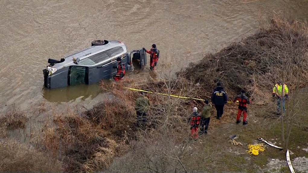 Crews remove van from Grand River
