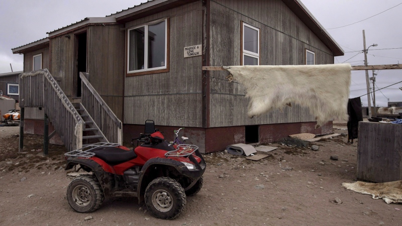 A polar bear hide hangs drying outside of a house in the town of Gjoa Haven, Nunavut on Saturday September 2, 2017.  THE CANADIAN PRESS/Jason Franson