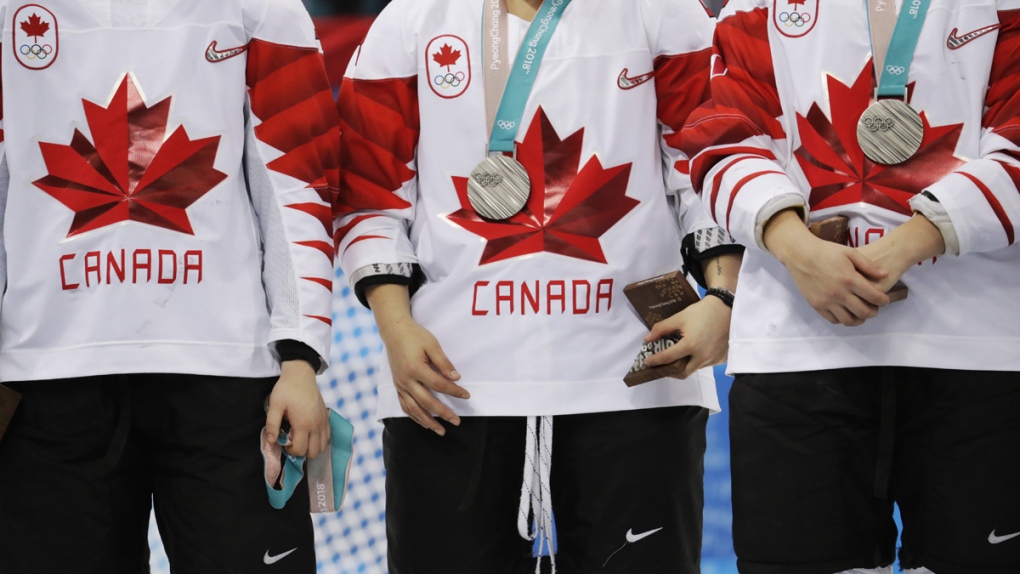 Jocelyne Larocque, at left, holds her silver medal
