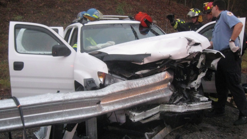Firefighters and rescue personnel attend the scene of a car accident in Bristol, Tenn., on Dec. 17, 2008. Authorities across Canada are awaiting test results from the U.S. before deciding what to do about thousands of safety devices with alleged defects that they say could cause guardrails to rip through cars and motorists instead of protecting them in crashes. (Handout / Joshua Harmon / Failingheads.com)