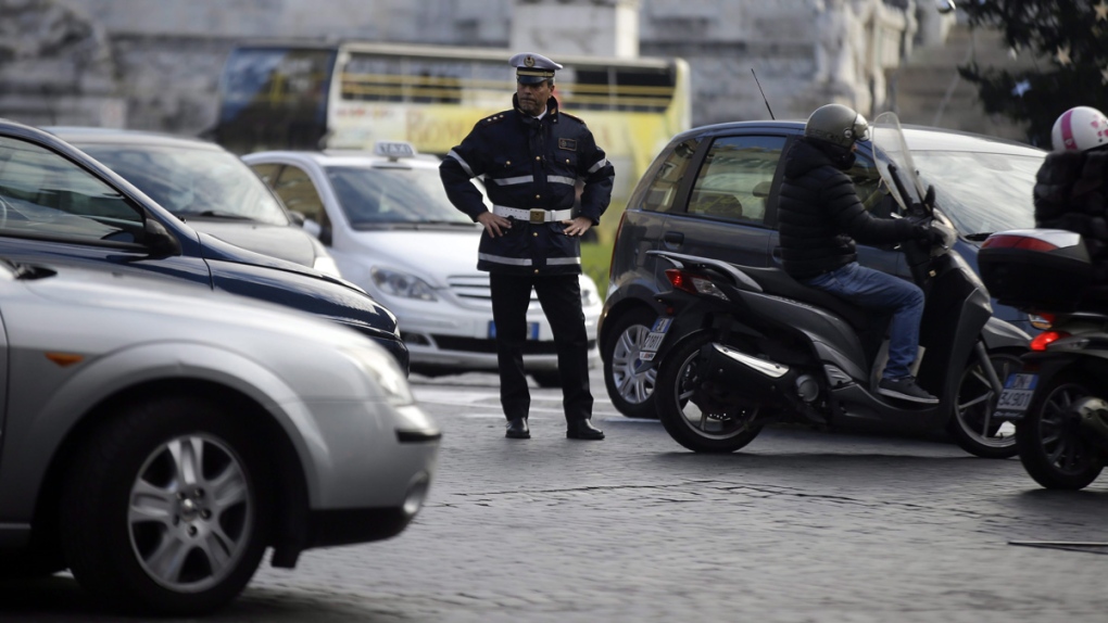 Police officer directs traffic in downtown Rome