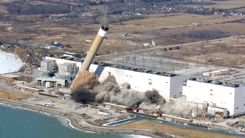Smoke and dust are seen after two giant chimneys at the Nanticoke generating station were toppled, Wednesday, Feb. 28, 2018. 