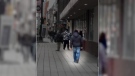 Photo of the attacker (blue jeans, black jacket, black hat) who randomly kicked a woman in the leg while she was walking down Rideau St. in Ottawa on Tuesday, March 6, 2018. (Stephanie McLeod/CTV Viewer)