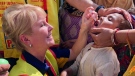 Windsor Rotarian Jennifer Jones administers polio vaccines to children in Delhi, India during a trip in March, 2018. (photo courtesy of Rotary International)