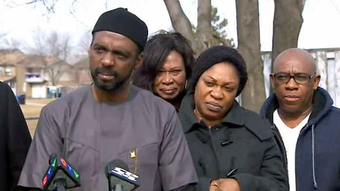Chidi Nwanyanwu, the Nigerian-Canadian Association president, stands along side the parents and family of Nnamdi Ogba, who was shot and killed in what police call a random attack in Etobicoke. 