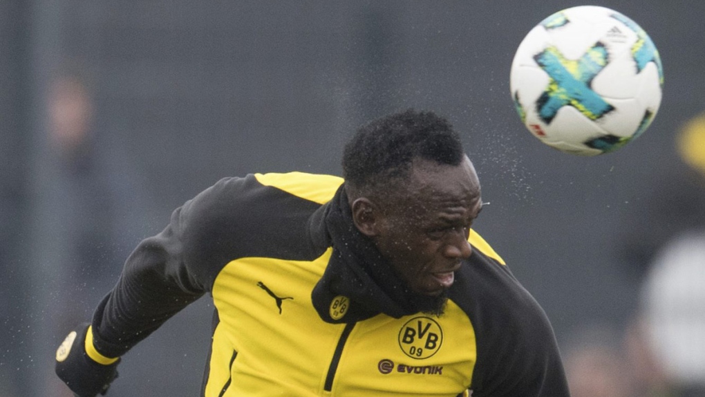 Usain Bolt heads the ball in Dortmund