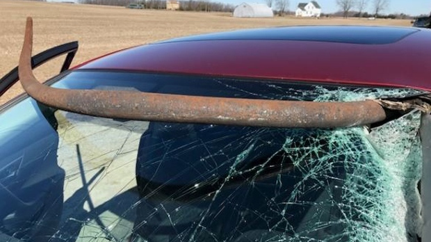 A metal pole is seen snaking through the windshield of a vehicle in Central Elgin, Ont., on Mar. 26, 2018. (West Region OPP)