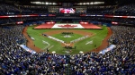 Baseball fans stand during the national anthems before the American League baseball game between the New York Yankees and the Toronto Blue Jays in Toronto, Thursday, March 29, 2018. THE CANADIAN PRESS/Frank Gunn