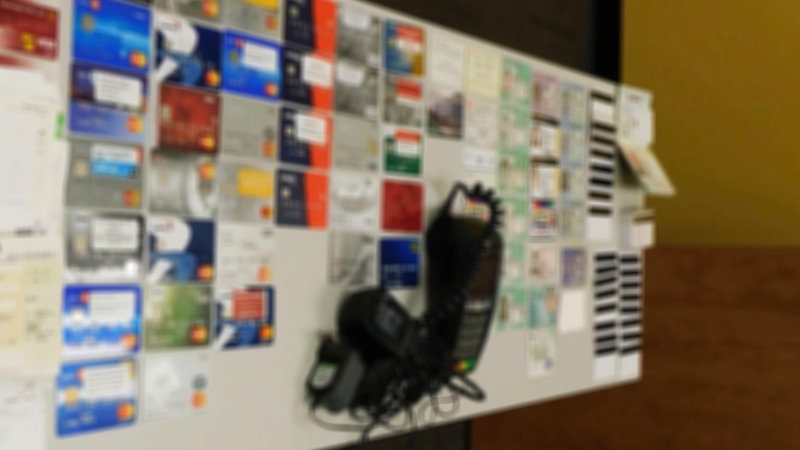 Debit cards, health cards, a debit machine and other items were seized from an alleged identity fraud lab in Kitchener. (Waterloo Regional Police)