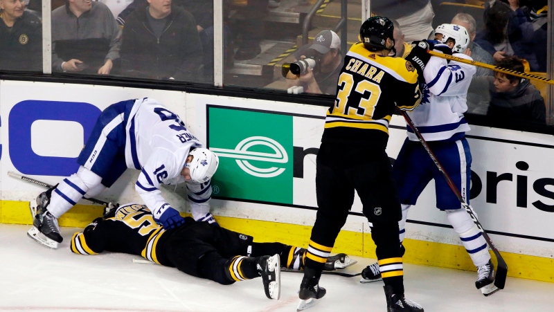 FILE - In this April 12, 2018, file photo, Boston Bruins defenseman Zdeno Chara (33) shoves Toronto Maple Leafs center Nazem Kadri (43) to retaliate for his late hit on Boston Bruins center Tommy Wingels (57), bottom left, as Maple Leafs center Mitchell Marner (16) starts to get up during the third period of Game 1 of an NHL hockey first-round playoff series, in Boston. Through the first two days of the Stanley Cup playoffs, there have already been a handful of hits to the head, two ejections, one suspension and the possibility of more to come. (AP Photo/Elise Amendola)