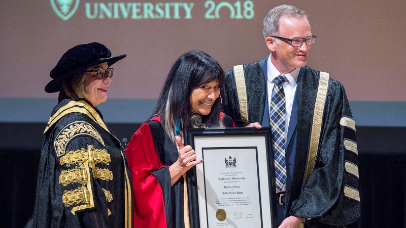 Buffy Sainte-Marie receives an honorary doctor of laws degree from Richard Florizone, right, president of Dalhousie University and Anne McLellan, chancellor, in Halifax on Tuesday, April 17, 2018. (THE CANADIAN PRESS/Andrew Vaughan)