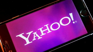 In this Dec. 15, 2016, file photo, the Yahoo logo appears on a smartphone in Frankfurt, Germany. (AP Photo/Michael Probst)