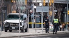 Police are seen near a damaged van in Toronto after a van mounted a sidewalk crashing into a number of pedestrians on Monday, April 23, 2018. THE CANADIAN PRESS/Aaron Vincent Elkaim