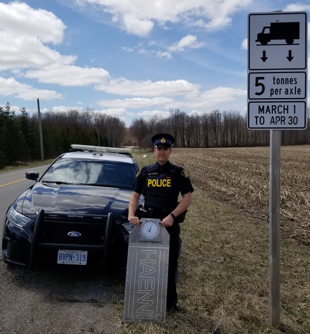 Officer with scale used to enforce loads
