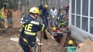 Emergency crews rescue a woman trapped in a trench at her Tillsonburg home. (Oxford OPP)