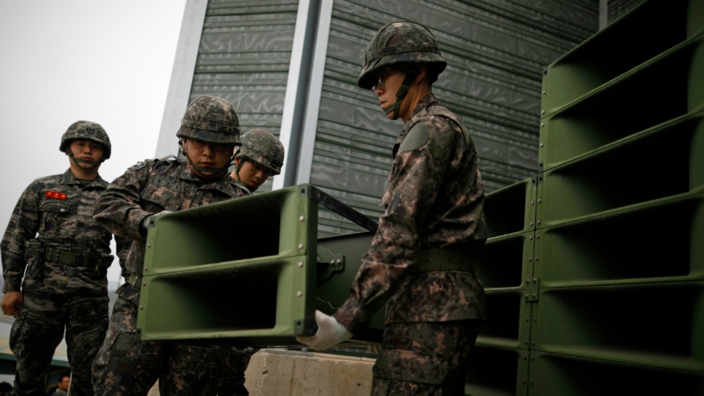 South Korean soldiers dismantling loudspeakers