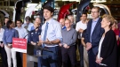 Prime Minister Justin Trudeau speaks as Ontario Premier Kathleen Wynne looks on during a visit to the TMMC Toyota Manufacturing facility in Cambridge, Ont. on Friday, May 4, 2018. THE CANADIAN PRESS/Peter Power