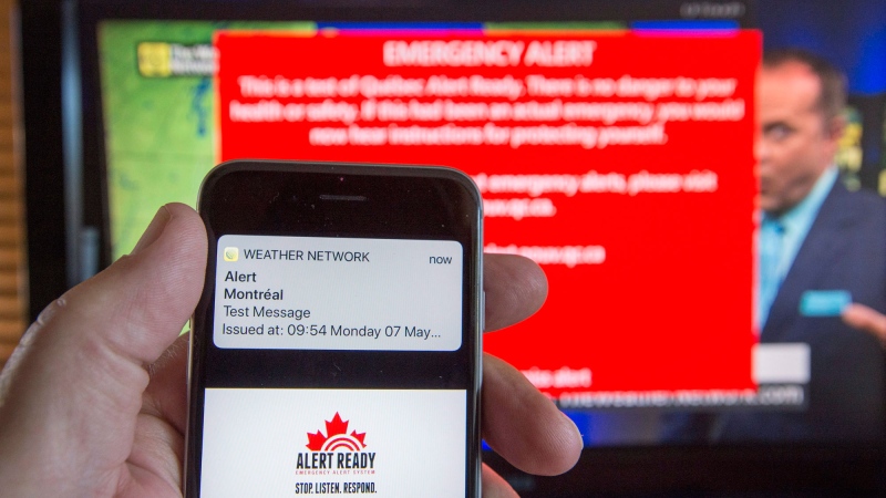 A smartphone and a television receive visual and audio alerts to test Alert Ready, a national public alert system Monday, May 7, 2018 in Montreal.THE CANADIAN PRESS/Ryan Remiorz
