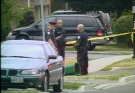 Toronto police investigate the scene of the double-murder in Scarborough on Wednesday, July 4, 2007.