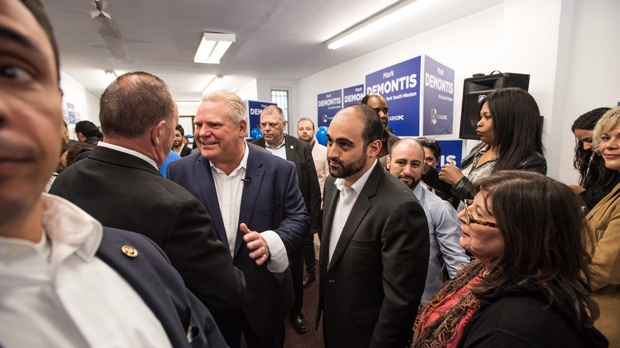 Mark DeMontis, middle, greets supporters with Ontario Progressive Conservative leader Doug Ford during his campaign office opening for York South-Weston in Toronto on Saturday, May 12, 2018. THE CANADIAN PRESS/Aaron Vincent Elkaim