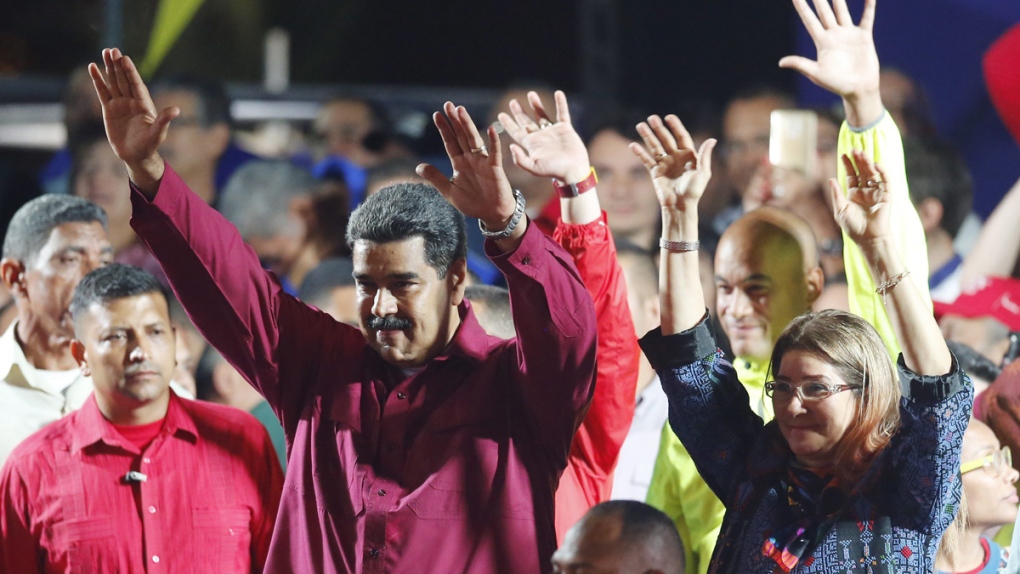 Nicolas Maduro waves to supporters in Caracas