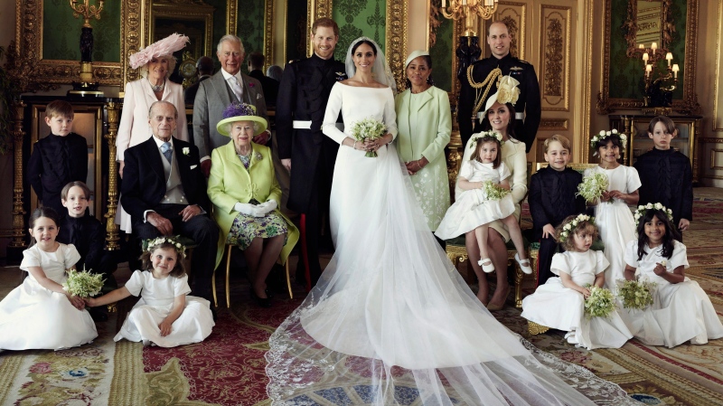In this photo released by Kensington Palace on Monday May 21, 2018, shows an official wedding photo of Prince Harry and Meghan Markle, center, in Windsor Castle, Windsor, England, Saturday May 19, 2018. Others in photo from left, back row, Jasper Dyer, Camilla, Duchess of Cornwall, Prince Charles, Doria Ragland, Prince William; center row, Brian Mulroney, Prince Philip, Queen Elizabeth II, Kate, Duchess of Cambridge, Princess Charlotte, Prince George, Rylan Litt, John Mulroney; front row, Ivy Mulroney, Florence van Cutsem, Zalie Warren, Remi Litt. (Alexi Lubomirski / Kensington Palace via AP)