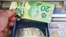 Money is removed from a bank machine in Montreal, Monday, May 30, 2016.(Ryan Remiorz / THE CANADIAN PRESS)