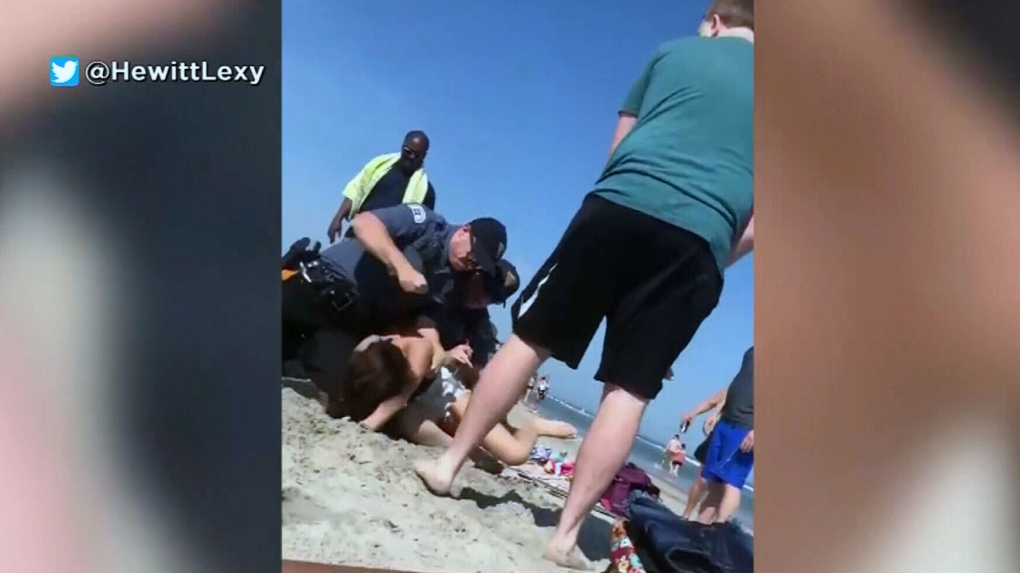 Officer captured punching woman at beach