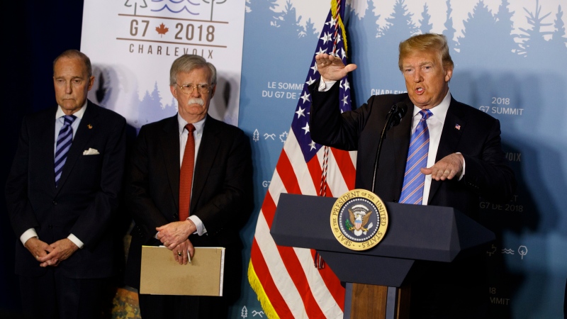 White House chief economic adviser Larry Kudlow, left, and National Security Adviser John Bolton look on as President Donald Trump speaks during a news conference at the G-7 summit, Saturday, June 9, 2018, in La Malbaie, Quebec, Canada. (AP Photo/Evan Vucci)
