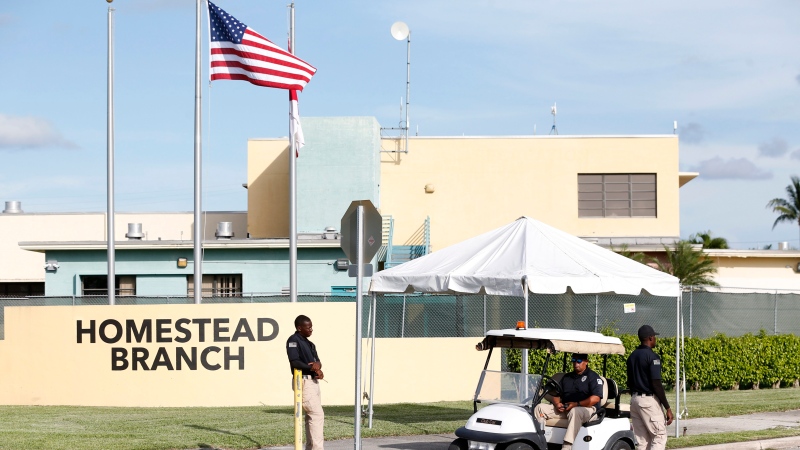 Security guards stand outside a former Job Corps site that now houses child immigrants, Monday, June 18, 2018, in Homestead, Fla. (AP Photo/Wilfredo Lee)