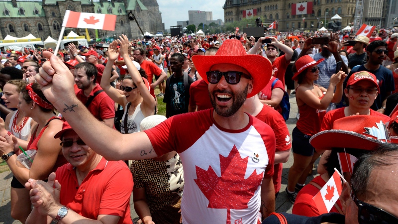 People cheer during Canada Day celebrations on Parliament Hill in Ottawa on Sunday, July 1, 2018. THE CANADIAN PRESS/Justin Tang