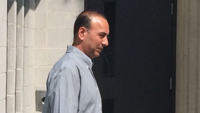 Manjit Parmar leaves the courthouse in Chatham after pleading guilty to four counts in a fatal collision on Highway 401 in Chatham in June, 2017. (Peter Langille / AM800 News)