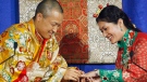 Sakyong Mipham Rinpoche, left, places a ring on his bride Princess Tseyang Palmo's finger during their Tibetan Buddhist royal wedding ceremony in Halifax on Saturday, June 10, 2006. (THE CANADIAN PRESS/Andrew Vaughan)