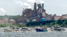 Fishing boats pass the Northern Pulp mill as concerned residents, fishermen and Indigenous groups protest the mill's plan to dump millions of litres of effluent daily into the Northumberland Strait in Pictou, N.S., on Friday, July 6, 2018. (THE CANADIAN PRESS/Andrew Vaughan)