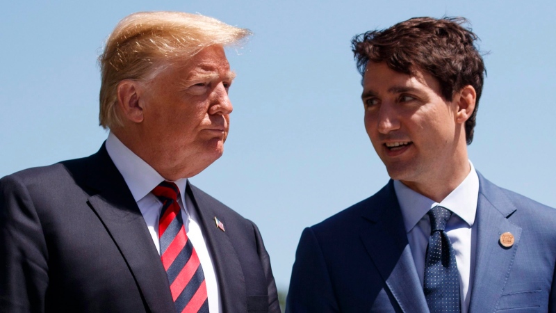 U.S. President Donald Trump talks with Canadian Prime Minister Justin Trudeau during a G-7 Summit welcome ceremony in Charlevoix, Canada on June 8, 2018. (AP Photo/Evan Vucci, File)