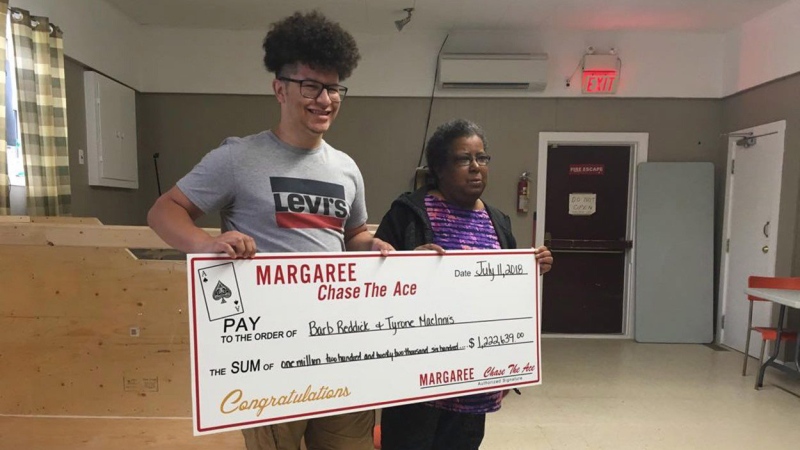 Tyrone MacInnis, left, and Barb Reddick, right, accept their Chase the Ace lottery prize in this undated handout photo. THE CANADIAN PRESS/HO, Bernice Curley, Chase The Ace Margaree 