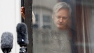 In this May 19, 2017 file photo, WikiLeaks founder Julian Assange closes a window after greeting supporters from the balcony of the London embassy in Ecuador. (AP Photo/Frank Augstein)