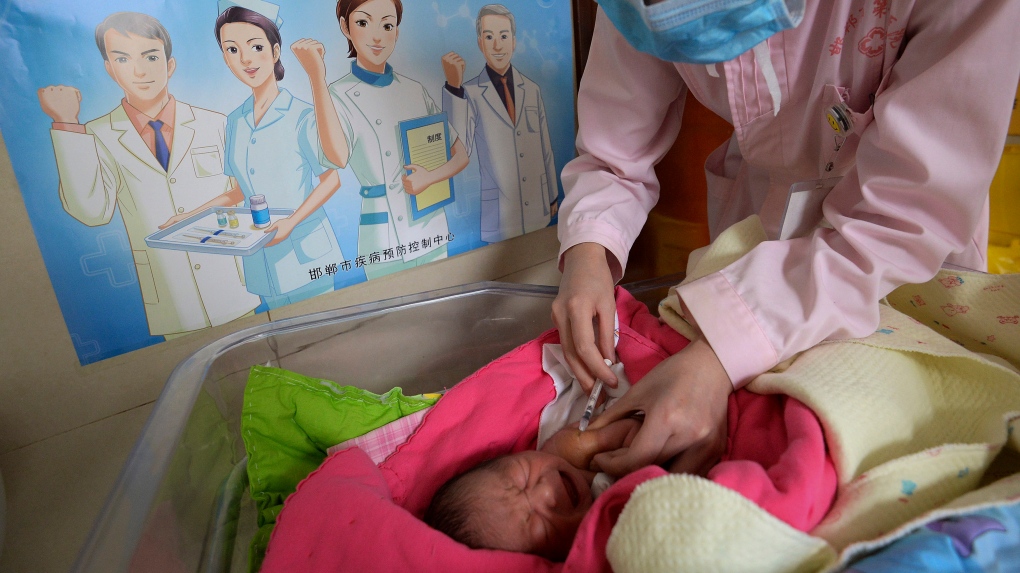 A baby receives a vaccine 