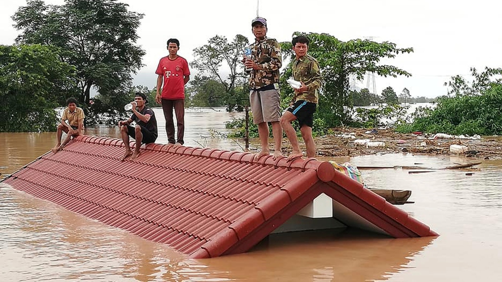 Villagers take refuge on a rooftop in Laos