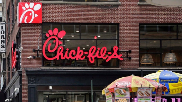 Chick-fil-A, the controversial American fast food company, said Wednesday that it will open its first Canadian restaurant in Toronto next year and has plans to bring about 15 of its locations to the Greater Toronto Area over the next five years. People walk past a new Chick-fil-A restaurant, Thursday, Oct. 1, 2015 in New York. THE CANADIAN PRESS/AP-Mark Lennihan
