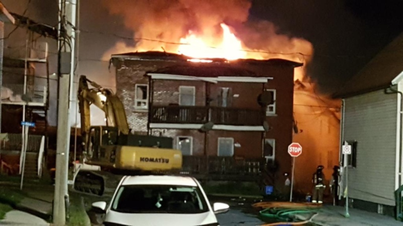 Flames re-ignite at an apartment building in Cornwall Thursday night, part of a massive fire that ripped through at least four buildings. (CTV Ottawa/Mike Mersereau, July 26, 2018) 