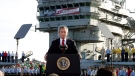 In this May 1, 2003 file photo, President George W. Bush speaks aboard the aircraft carrier USS Abraham Lincoln off the California coast. (AP Photo/J. Scott Applewhite, File)