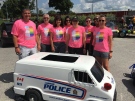 London police officers, including Chief John Pare, at left, wear pink T-shirts to march in the Pride London parade on Sunday, July 29, 2018.
(Brent Lale / CTV London)